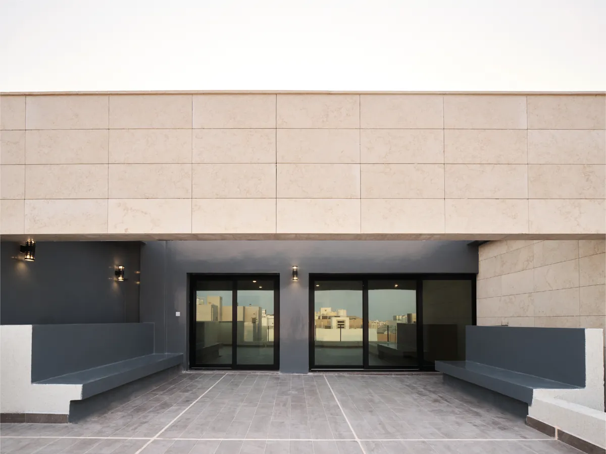 Covered entrance court in stone cladding