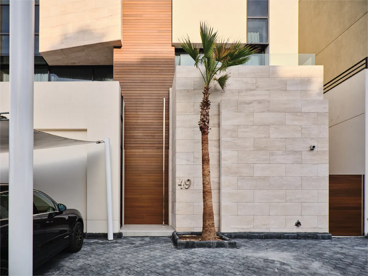 Entrance in stone and timber with palm